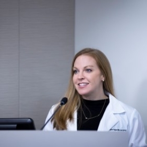 blonde woman at podium speaking