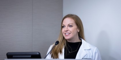 blonde woman at podium speaking