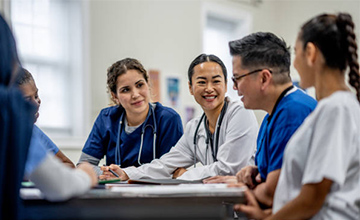 Medical professionals laughing at table