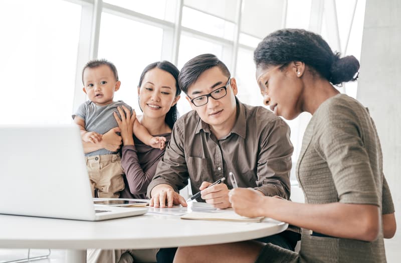 family at a table filling out paperwork