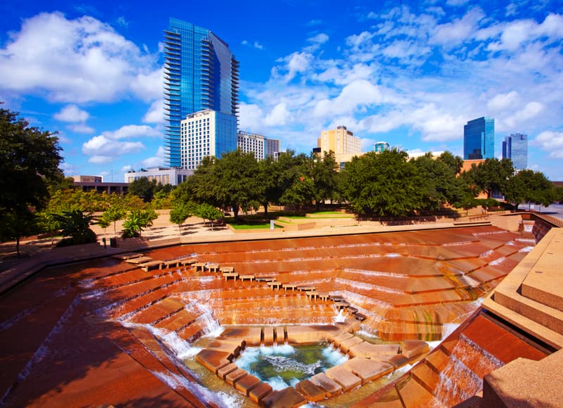 a Fort Worth water gardens the skyline behind it