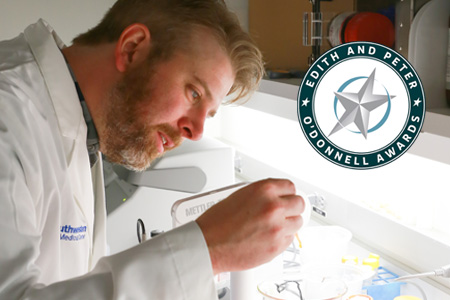 A male medical professional looking into a stethoscope
