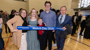 Emily Hoffer, second from left, surrounded by her supportive family, celebrates her match.