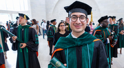 Angel Sandoval, M.D., proudly displays his diploma.