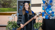 Maralice Conacci-Sorrell, Ph.D., Associate Professor of Cell Biology and in the Children’s Medical Center Research Institute at UT Southwestern, holds the Stembridge Mace she carried during the academic procession. The symbol represents the torch of learning and passing of knowledge from teacher to student over generations.