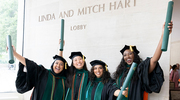 From left: Afeefah Khazi-Syed, M.D., Tenzin Palkyi, M.D., Davyani Srivastava, M.D., and Zureyat Sola-Odeseye, M.D., raise their diplomas in joyous celebration.