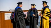 Ambassador Hutchison presents Dr. Cano, left, with the Excellence in Teaching Award, honoring his impact on future public health leaders.