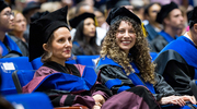 Excitement radiates from Clinical Psychology graduate Monica Garza Saenz, Ph.D., (right) as she sits beside Veronica Bordes Edgar, Ph.D., Professor of Psychiatry and Pediatrics, after crossing the stage.