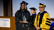 Zahria Lea Griggs, M.P.H., left, is honored with the Community Engagement Award, presented by Ambassador Hutchison and Dean Omer.