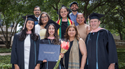 From left in caps and gowns: Graduates Kolambi Kharbanda, M.P.H., Maya Khemsara, M.P.H., Mahder Tracy, M.P.H., and Rick Press, M.P.H., celebrate in a photo with faculty and staff.
