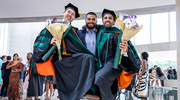 Graduates Daniel Shay, M.D., (left) and Faraaz Azam, M.D., (right) are lifted in honor of their achievement by fourth-year medical student Alex Turner.