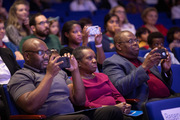 The family of Dr. Dale Okorodudu proudly capture video of his acceptance speech.