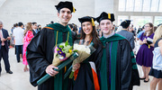 Graduation brings bouquets and smiles for graduates (from left) John Tycher, M.D., Elizabeth Twichell, M.D., and William Burton, M.D.