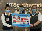 Staff in Guest and Patient Services show support for UTSW’s health care heroes. From left to right: Ximena Acevedo, Ibrahim Ali, and Allyson Hart