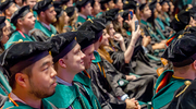 Medical students anxiously await their turns to receive diplomas.