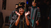Riddhi Patel, M.D., looks up at her loved ones while walking across the stage.
