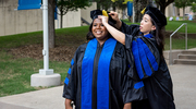 Adrianna Martin, Ph.D., (left) receives an assist from Courtney Tran, Ph.D. – both are Clinical Psychology grads.