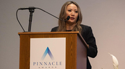 Ms. Bui graciously accepts her Pinnacle Award for Excellence.
