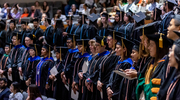OSPH faculty, staff, and students stand together in reflection and pride as the commencement ceremony concludes.