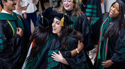 Center front: Joelle Abdallah, M.D., gives a big hug to a fellow classmate as they both complete medical school. Top, from left, are graduates Jai Prasadh, M.D., Sarah Dolphin, M.D., and Nina Stephen, M.D.
