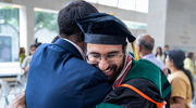 Ahmed Alshaikhsalama, M.D., receives a big hug for his achievement.