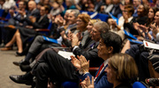 Attendees applaud Dr. Vazquez.