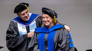 Stuart Ravnik, Ph.D., Associate Dean in the Graduate School and Assistant Professor of Cell Biology, hoods Molecular Microbiology graduate Brittany Stewart, Ph.D.