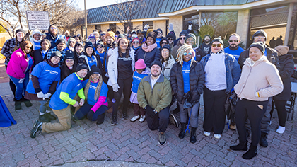 large gathering of UTSW workers outdoors in local neighborhood