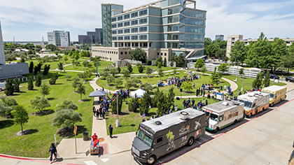 outdoor overhead photo of several colorful food trucks near UT Southwestern campus
