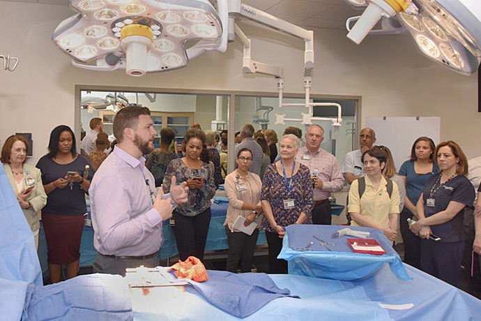 At 49,000 square feet, the new, state-of-the-art Simulation Center is one of the largest simulation cen- ters in the United States. Matthew Kosemund, a Clinical Simulation Educator, explains to a tour group that the Simulation Center replicates and creates virtual environments for training in clinical care. Matthew Kosemund explains to a tour group how the Simulation Center works