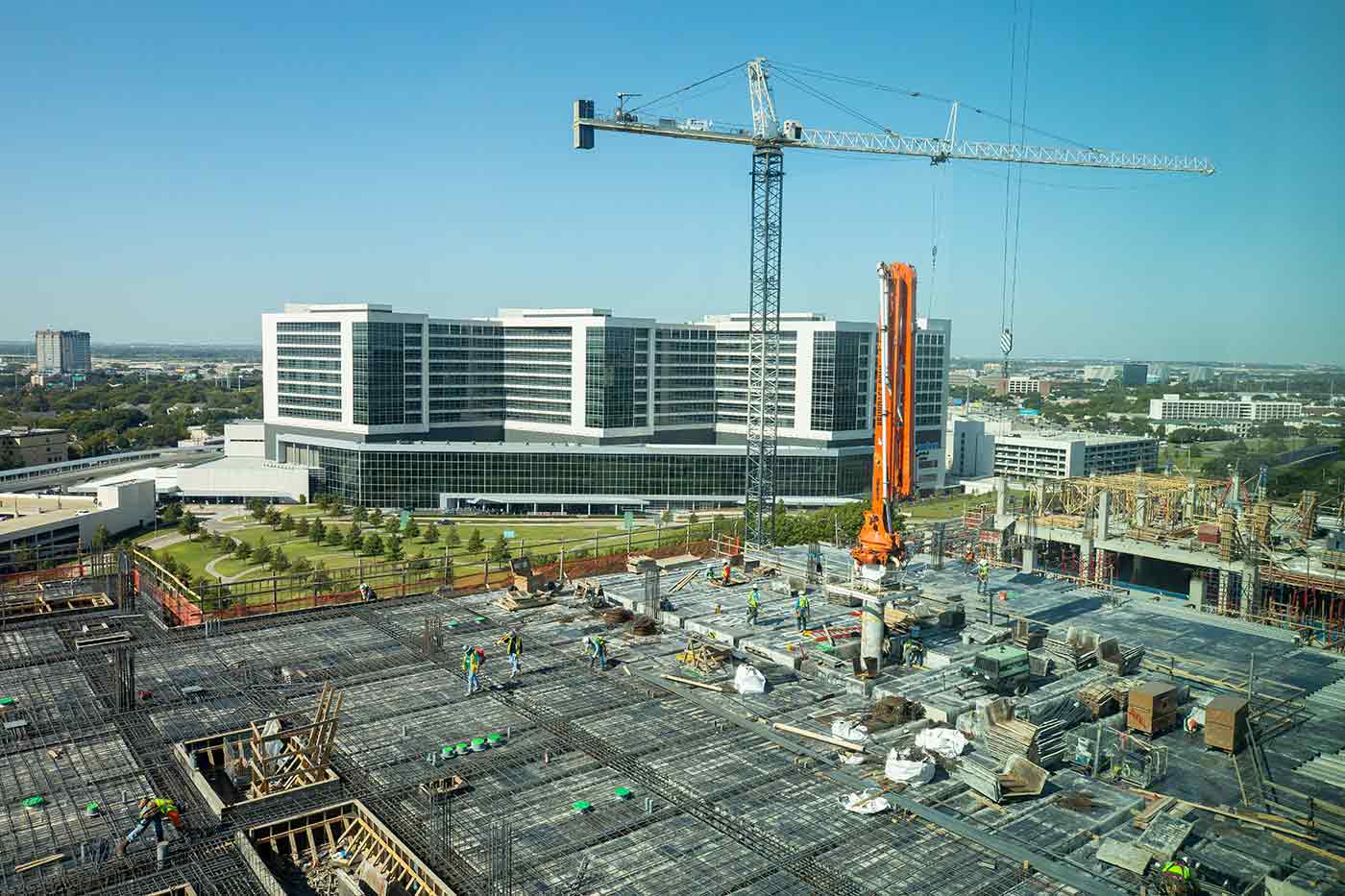 In October, construction crews worked diligently to complete projects on North Campus. Workers on a building walking on rebar, with construction crane and large building in background
