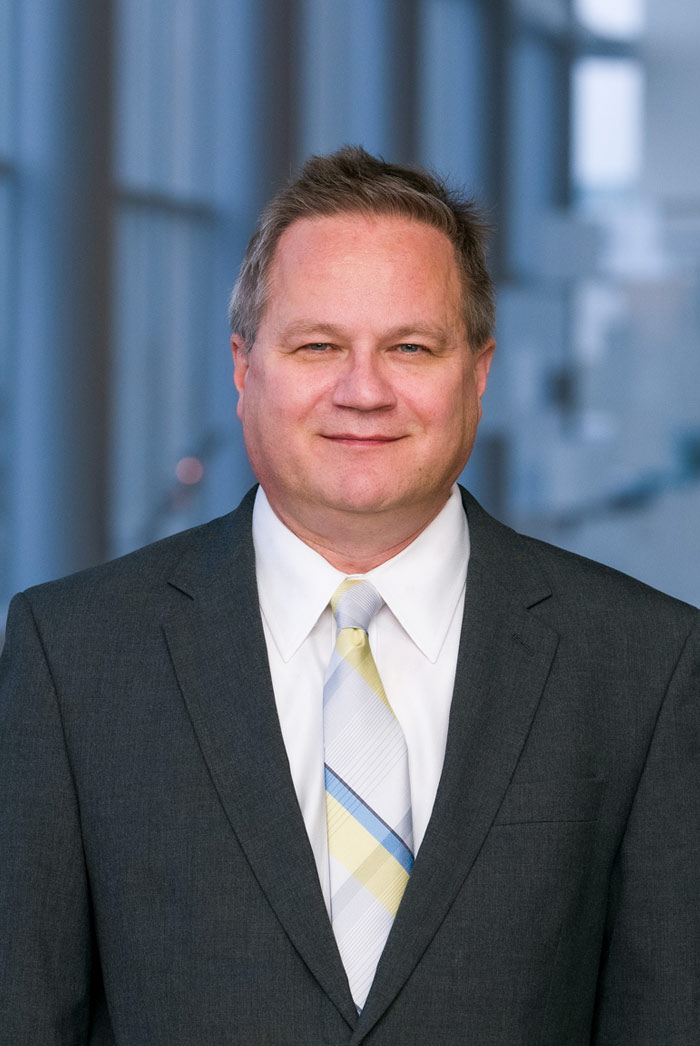 Dr. Christoph Lehmann Man with light brown hair, wearing dark grey suit