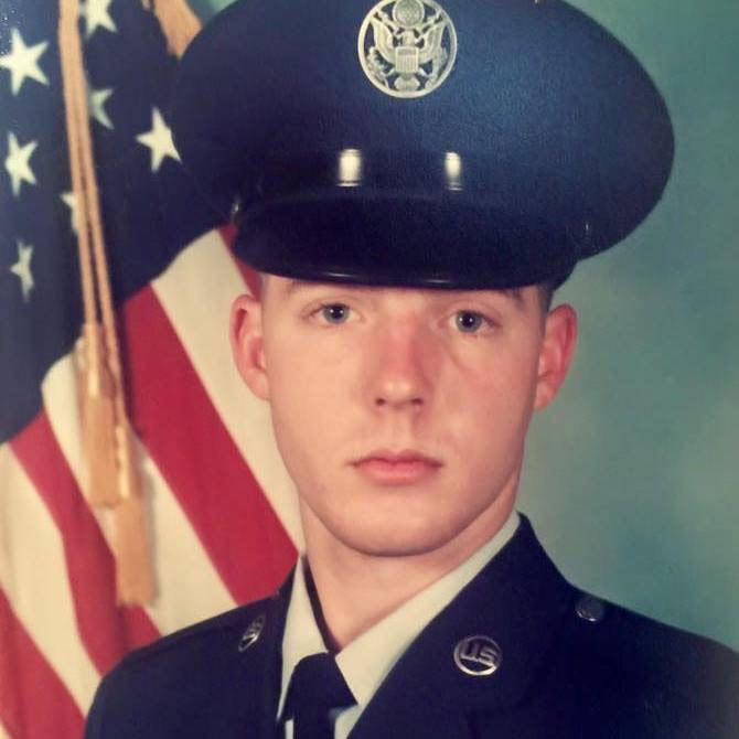 Michael Dryer, a former Air Force as a financial supervisor, is now a Registered Respiratory Therapist at UTSW. Man in dress uniform in front of flag