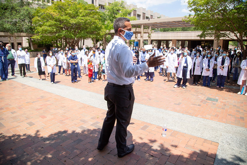 Dr. Marc Nivet, EVP for Institutional Advancement, addressed rally attendees. Black man with mask, in dress shirt and slacks speaks to crowd
