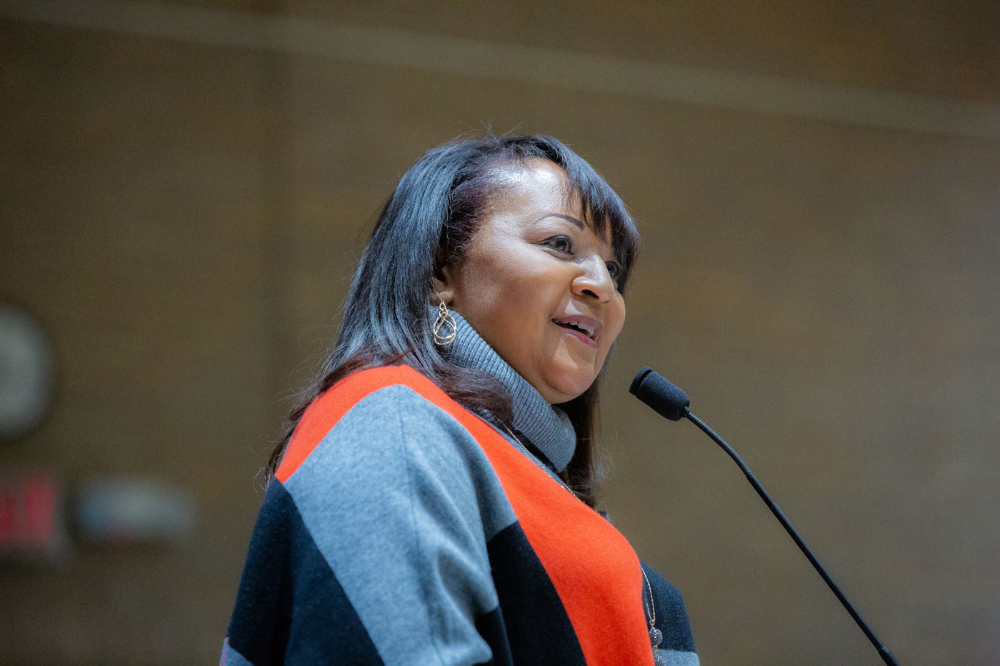 Dr. Shawna Nesbitt, Associate Dean of Student Diversity and Inclusion at UT Southwestern, addresses guest during the Annual Martin Luther King Jr. Commemoration Celebration in 2019. Dr. Nesbitt oversees the Office of Students Diversity and Inclusion which in part manages a wide array of programming to educate medical student and others on campus about the role diversity plays in medicine. Woman in orange and black top and speaking into mic