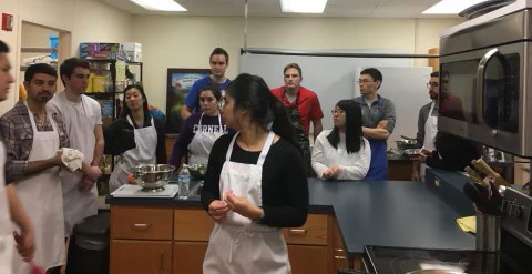 Mr. Huffaker enjoys culinary night during his ambulatory clerkship. Part of the curriculum to emphasized life-long learning and healthy eating for physicians and our patients. Group of people in a kitchen.