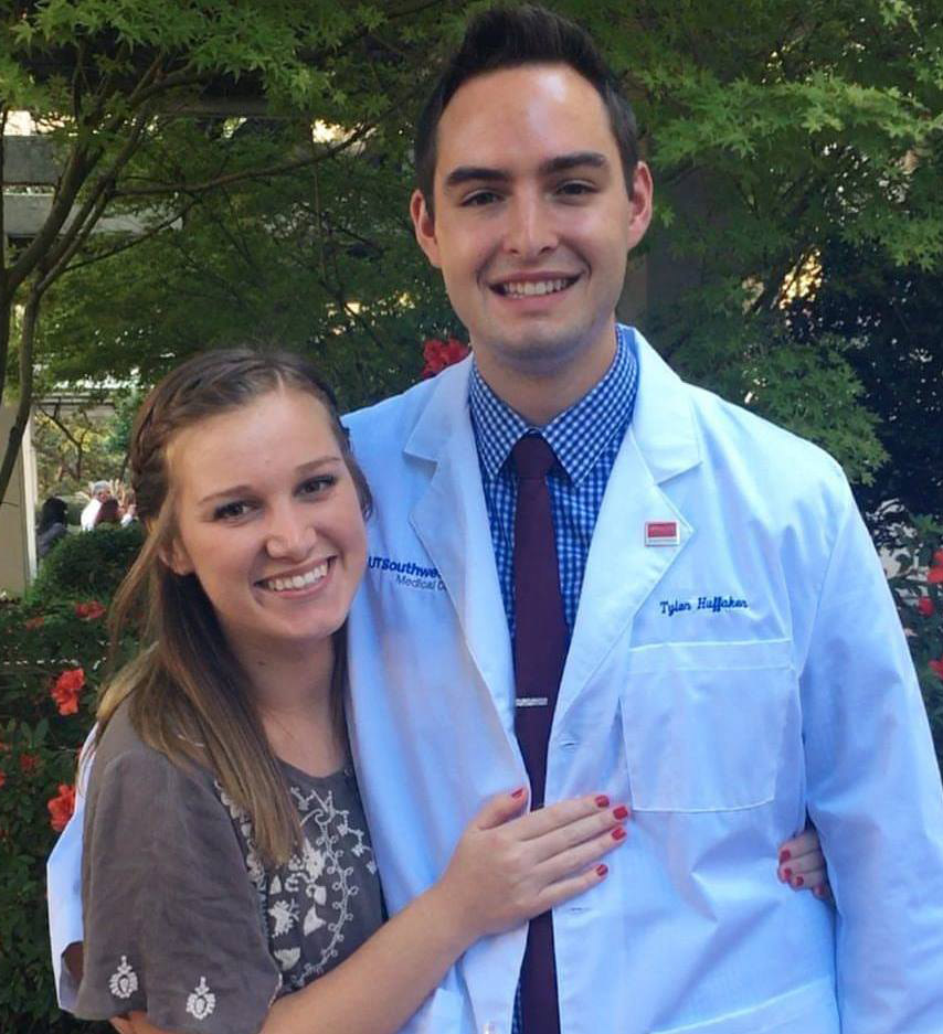 Mr. Huffaker appears at his White Coat Ceremony with his wife Aleigh. Man in white lab coat with woman in grey shirt, both smiling
