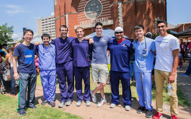 Mr. Umbach poses with fellow medical students on a health care mission Group of people with locked arms standing outside