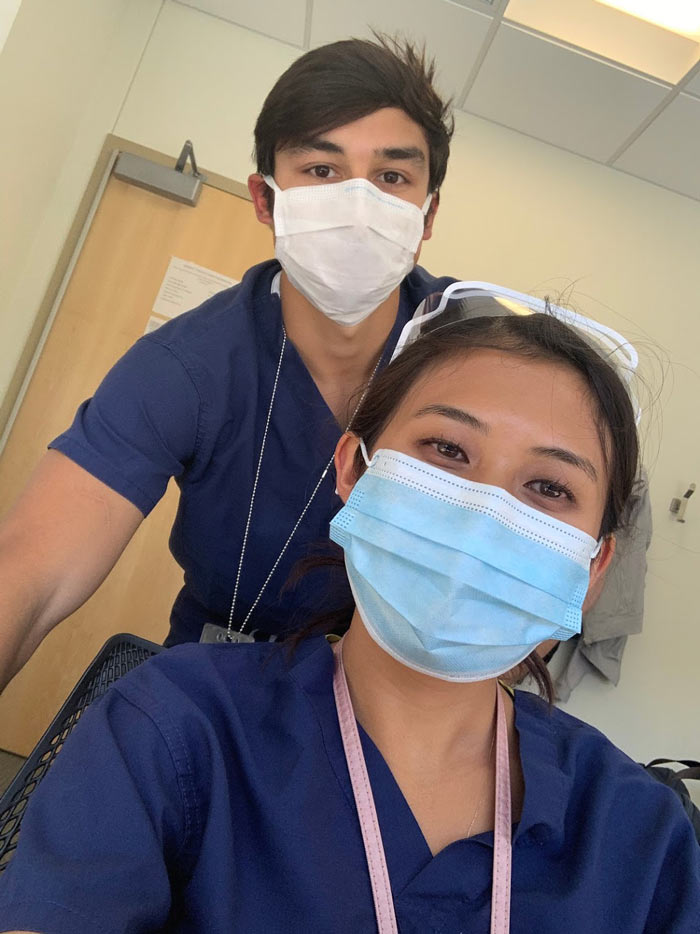 Priscilla Tanamal and Daniel Gelvez together on a break between patient cases. Two people in scrubs and masks taking selfie together