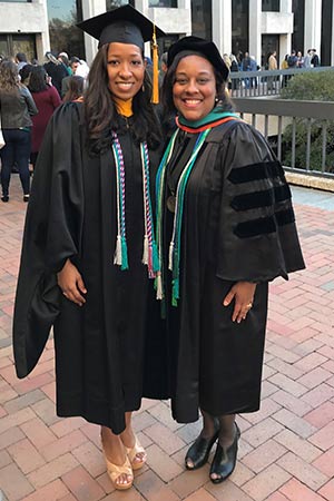 carolyn= Women in graduation black robes