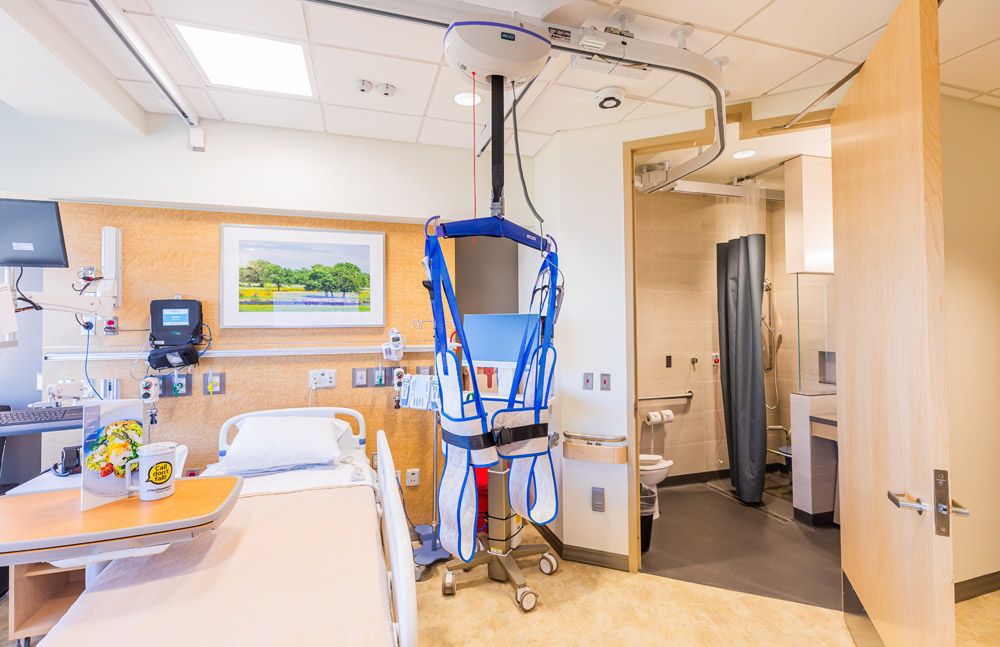 Patient rooms in the epilepsy monitoring unit are uniquely outfitted with safety harnesses suspended from the ceiling to help patients independently move around their rooms. Patient room with suspended harness for movement around room.