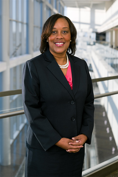 Dr. Bradley-Guidry woman in navy blue suit