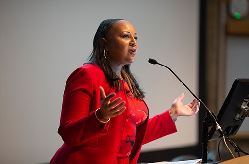 woman in red at podium