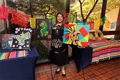 woman standing near colorful paintings