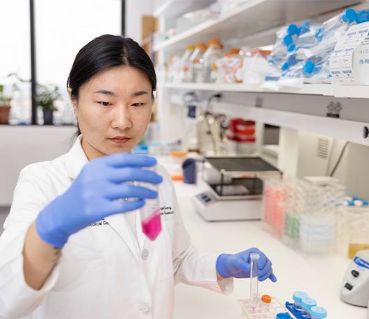 Rui Chen woman in lab holding test tubes