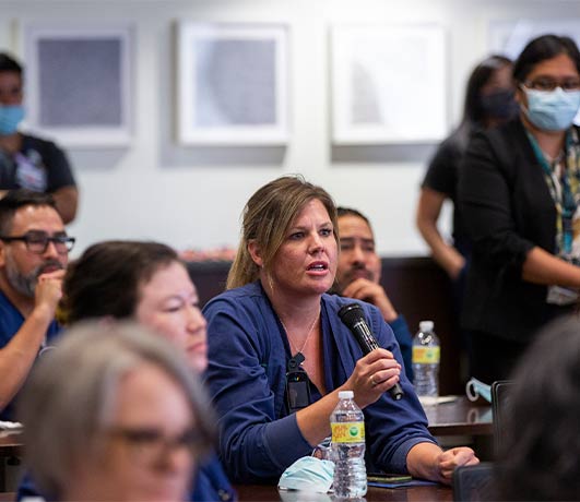 person with microphone TBD