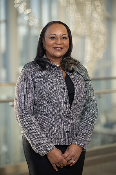 Dr. Nesbitt woman in black and white suit