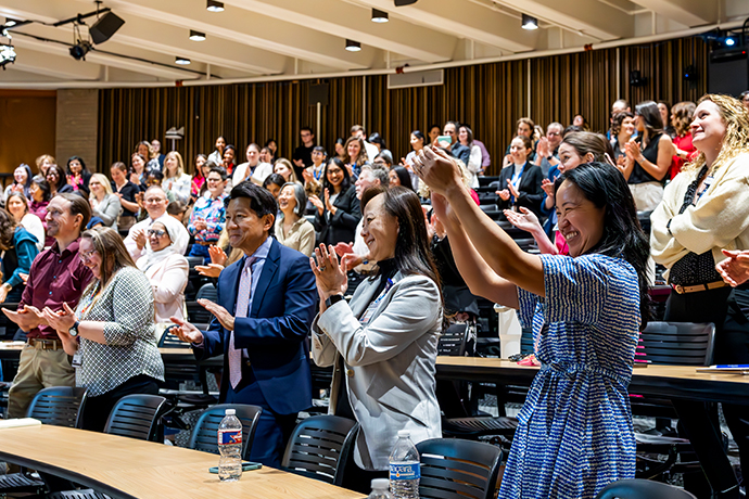 Audience in theatheater-style classrooms offers a standing ovation.