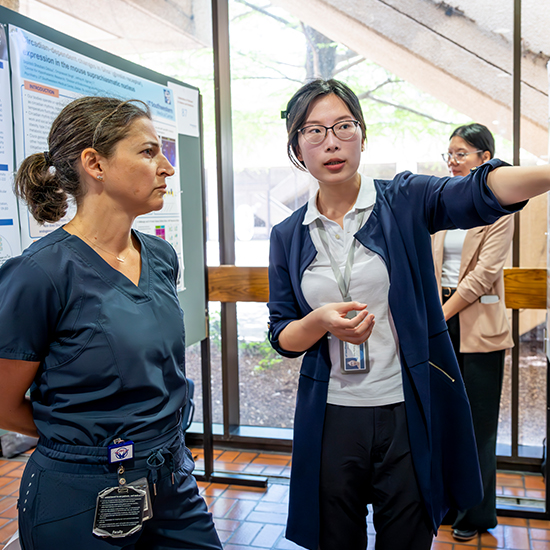 Two women looking at a poster.