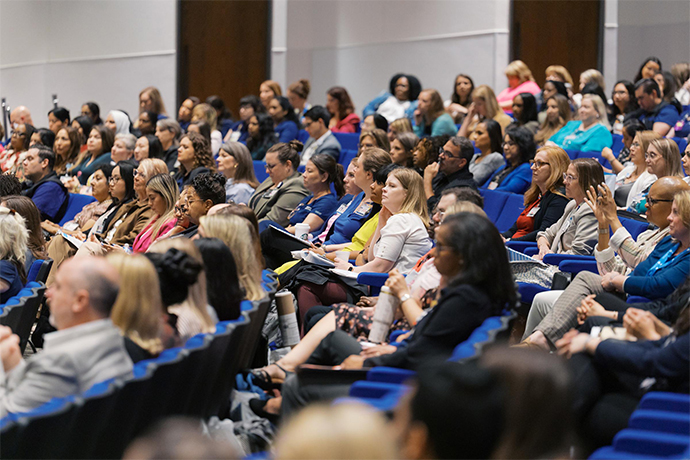Audience a the Celebration of Excellence. A group of people seated in a classroom theater, intent on the stage.
